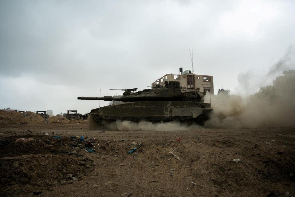 An Israeli soldier rides in a tank amid the ongoing ground operation against Hamas in this handout image released November 20, 2023.