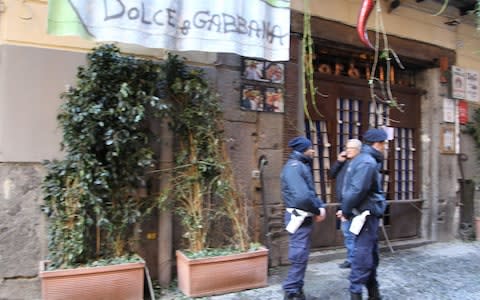 Police outside the pizzeria in Naples after the bombing - Credit: Salvatore Esposito/Barcroft