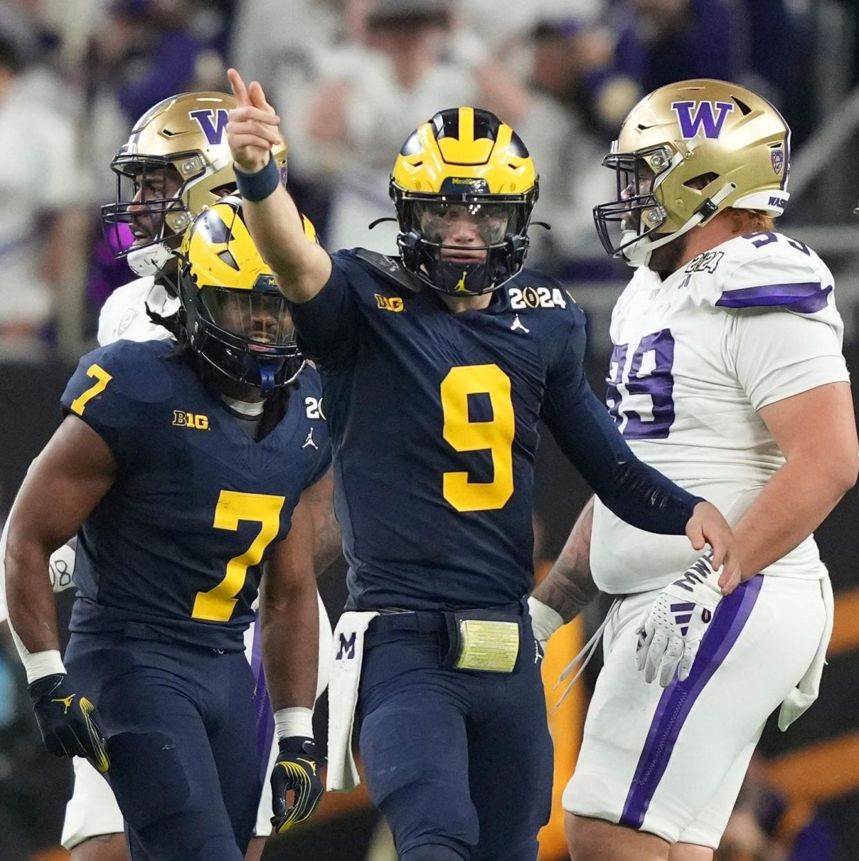 Michigan quarterback J.J. McCarthy points down the field during the second half of the College Football Playoff national championship game against Washington at NRG Stadium in Houston, Texas on Monday, Jan. 8, 2024.