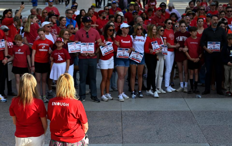 Covenant School families lock arms and hold hands to demonstrate for gun safety and common sense gun laws as part of a three-mile human chain from the Monroe Carell Jr. Children’s Hospital at Vanderbilt to the Tennessee State Capitol Tuesday, April 18, 2023, in Nashville, Tenn. 