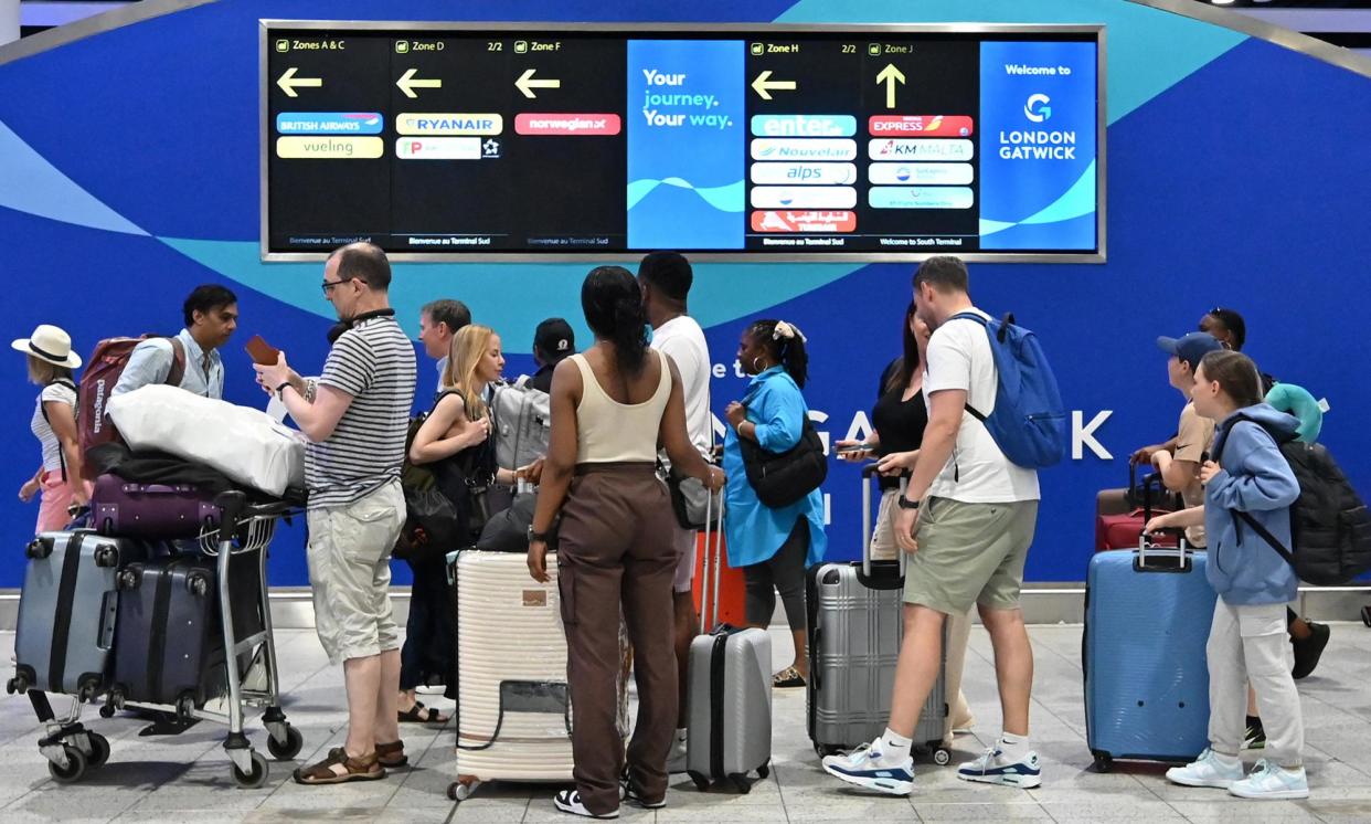 <span>Passengers orienting themselves at Gatwick airport on Saturday; 408 flights were cancelled in the UK.</span><span>Photograph: Justin Tallis/AFP/Getty Images</span>