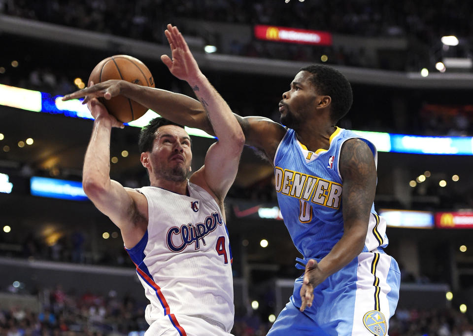 Los Angeles Clippers guard J.J. Redick, left, looks to shoot as Denver Nuggets guard Aaron Brooks defends during the first half of an NBA basketball game, Tuesday, April 15, 2014, in Los Angeles. (AP Photo/Mark J. Terrill)