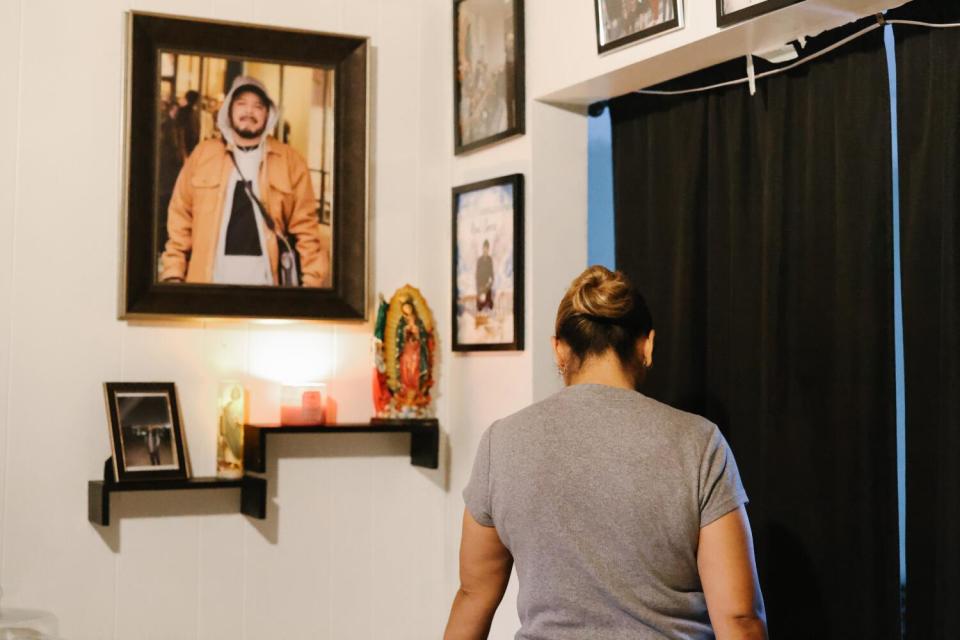 Wendy Solano stands in front of an altar for her late husband Jose Raul Garcia Leon, who died in February from silicosis.