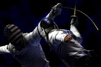 Tamas Meszaros, right, of Hungary and Race Imboden of United States fence during the men's team foil round of 16 match of the FIE World Fencing Championships in Budapest, Hungary, Monday, July 22, 2019. (Tibor Illyes/MTI via AP)