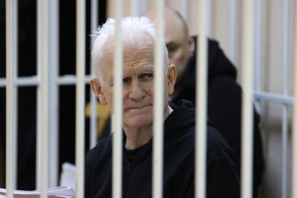TOPSHOT - Nobel Prize winner Ales Bialiatski is seen in the defendants' cage in the courtroom at the start of the hearing in Minsk on January 5, 2023. - Jailed Nobel Prize winner Ales Bialiatski went on trial in Minsk in what supporters see as a bid to clamp down on Viasna, Belarus's top rights group which he founded. - Belarus OUT (Photo by Vitaly PIVOVARCHIK / BELTA / AFP) / Belarus OUT (Photo by VITALY PIVOVARCHIK/BELTA/AFP via Getty Images)
