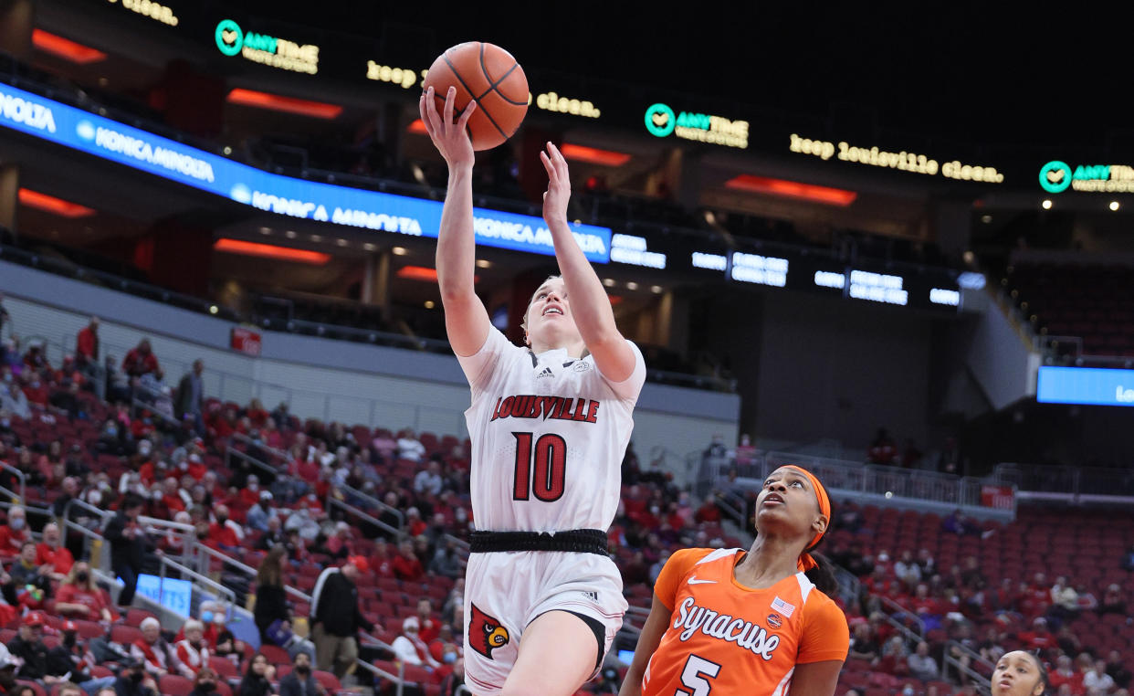 Hailey Van Lith of the Louisville Cardinals goes up to the basket for a layup in a women's college basketball game against Syracuse.