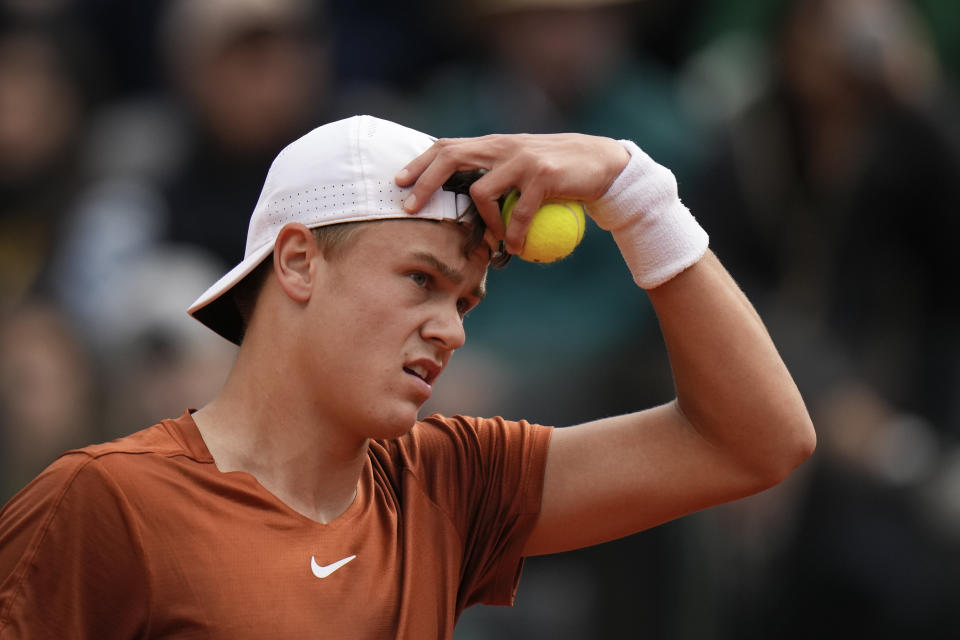 Denmark's Holger Rune is dejected after losing a point to Daniil Medvedev of Russia during the men's final tennis match at the Italian Open tennis tournament in Rome, Italy, Sunday, May 21, 2023. (AP Photo/Alessandra Tarantino)