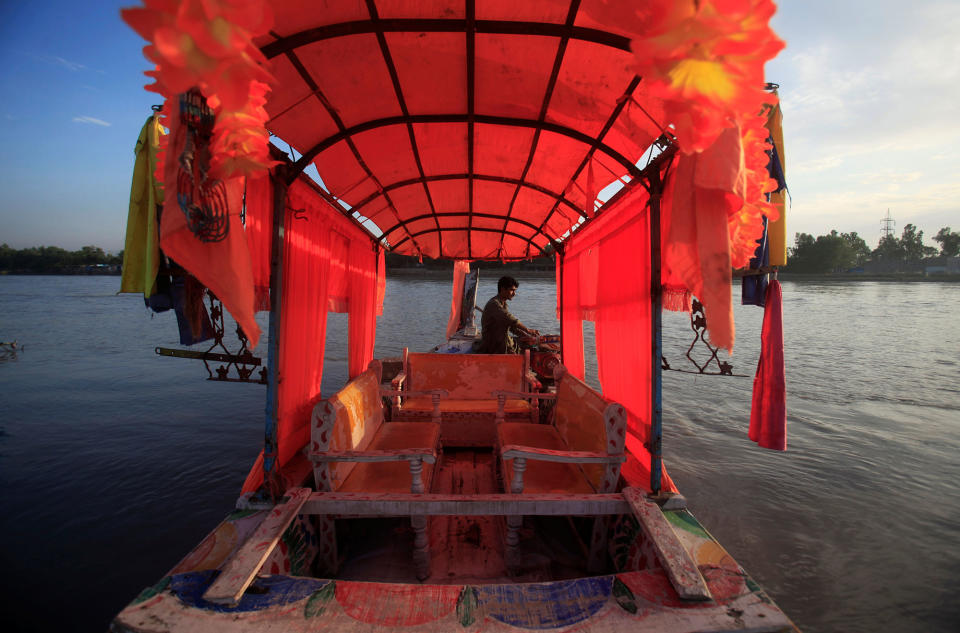 <p>A man waits for customers to offer a ride on a decorated tourist boat in the Sardaryab river at Charsadda, on the outskirts of Peshawar, Pakistan, August 22, 2016. (Fayaz Aziz/Reuters) </p>