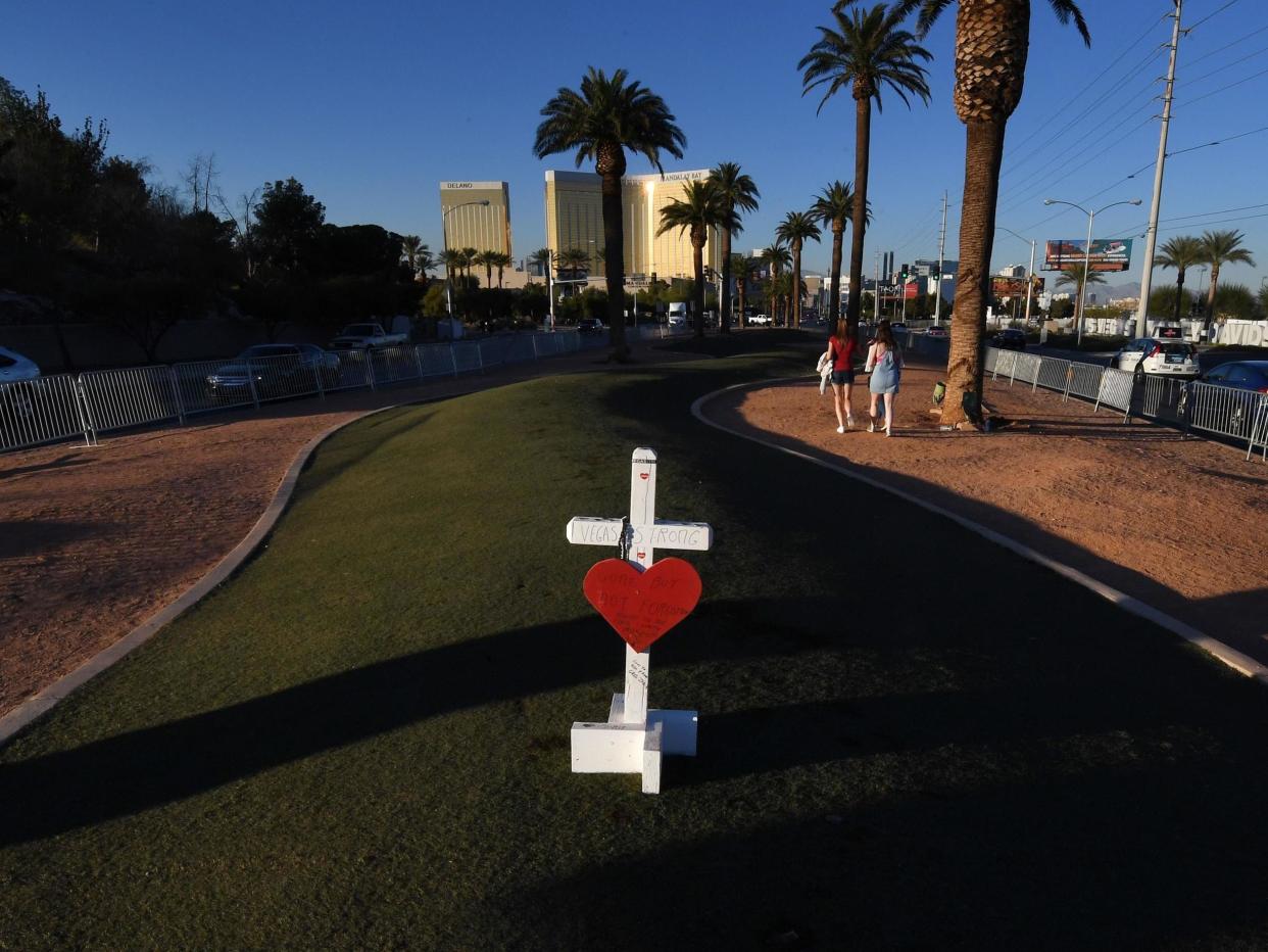 A solitary cross at a memorial site in front of the Mandalay Bay Hotel for the victims of the worst shooting in US history: Mark Ralson/AFP via Getty Images