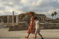 Tourists visit the ancient site of Antalya, southern Turkey, on Sunday, June 20, 2021. Hotels in Turkey's Antalya region, a destination beloved by holidaymakers, are preparing to finally resume operations as they expect the return of international tourists after months of setbacks caused by the pandemic that halted travel. (AP Photo/Emrah Gurel)