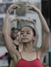 In this photo taken Nov. 25, 2012, Filipino slum dweller Jessa Balote rehearses during a class at Ballet Manila in the Philippine capital. Balote, who used to tag along with her family as they collect garbage at a nearby dumpsite, is a scholar at Ballet Manila's dance program. As an apprentice, she makes around 7,000 pesos ($170) a month, sometimes double that, from stipend and performance fees. (AP Photo/Aaron Favila)