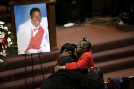 FILE PHOTO: Janet Cooksey (L), is embraced as she attends the funeral for her son Quintonio LeGrier in Chicago, Illinois, January 9, 2016. REUTERS/Joshua Lott/File Photo