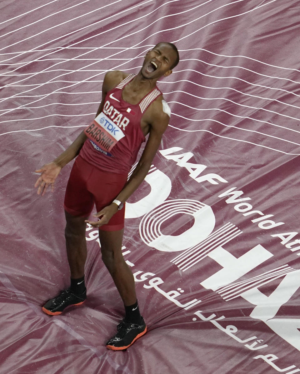 Gold medalist Mutaz Essa Barshim, of Qatar, celebrates after the men's high jump final at the World Athletics Championships in Doha, Qatar, Friday, Oct. 4, 2019. (AP Photo/Nick Didlick)