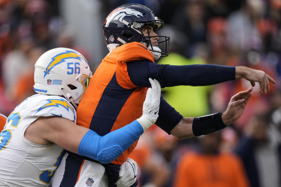 Los Angeles Chargers defensive end Morgan Fox (56) hits Denver Broncos quarterback Jarrett Stidham (4) during the first half of an NFL football game, Sunday, Dec. 31, 2023, in Denver. (AP Photo/David Zalubowski)