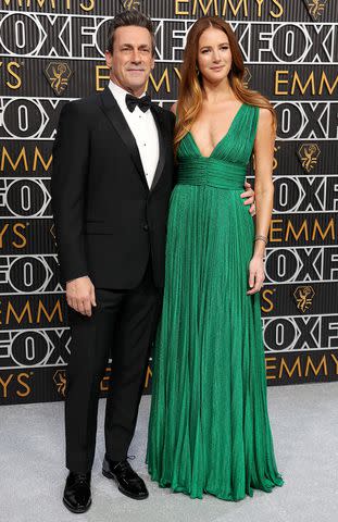 <p>Kevin Mazur/Getty</p> Jon Hamm and Anna Osceola pose on the 2023 Emmys red carpet