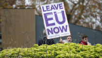 Pro Brexit protesters hold placards trying to get media attention near Parliament in London, Friday, Nov. 16, 2018. Britain's Prime Minister May still faces the threat of a no-confidence vote, after several Conservative Party lawmakers said they had written letters asking for one. (AP Photo/Alastair Grant)