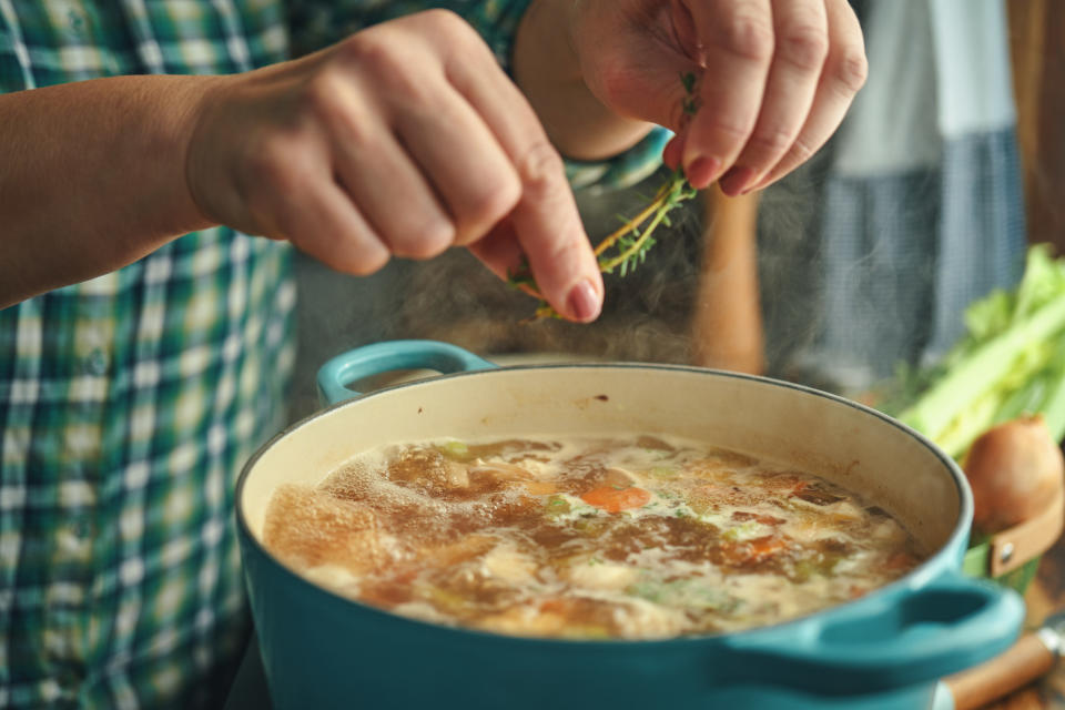 Person making soup at home