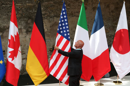 FILE PHOTO - Flags are placed at the G7 summit in Taormina, Italy, May 26, 2017. REUTERS/Alessandro Bianchi