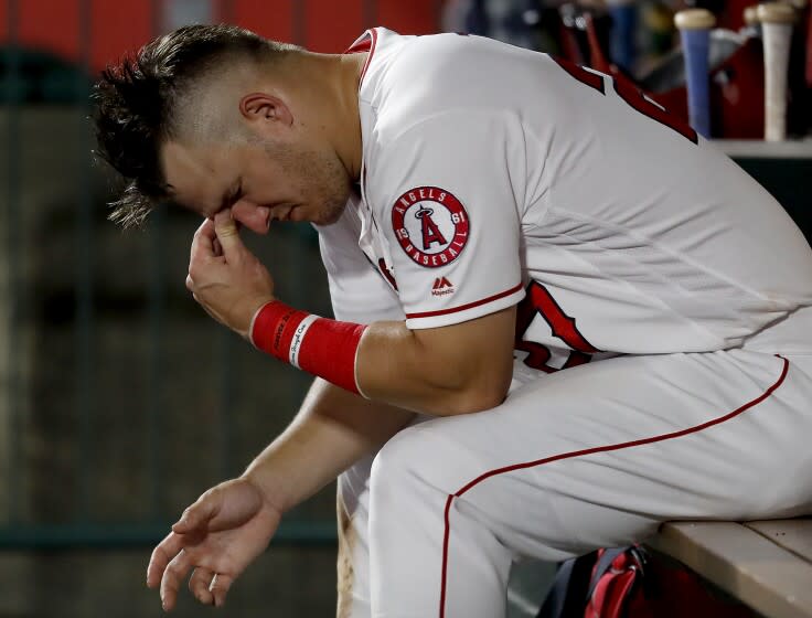 ANAHEIM, CALIF. - AUG. 13, 2019. Angels center fielder Mike Trout sits in the dugout in the ninth inning.