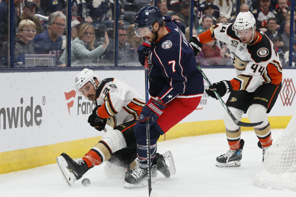 Anaheim Ducks' Sam Carrick, left, and Columbus Blue Jackets' Sean Kuraly vie for the puck during the third period of an NHL hockey game Tuesday, Oct. 24, 2023, in Columbus, Ohio. (AP Photo/Jay LaPrete)