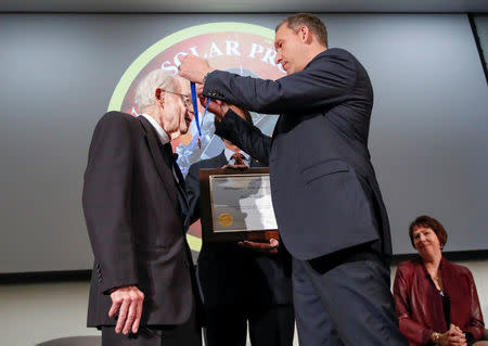 Dr. Eugene Parker, University of Chicago astrophysicist, (L), receives a NASA Distinguished Public Service Medal from Dr. Thomas Zurbuchen, Associate Administrator for the Science Mission Directorate at NASA, (R), during the announcement on its first mission to fly directly into the sun's atmosphere at the University of Chicago in Chicago, Illinois, U.S. May 31, 2017. REUTERS/Kamil Krzaczynski