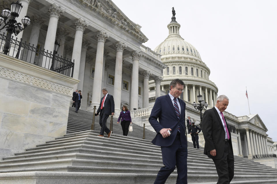 Rep. Thomas Massie, R-Ky., left, and Rep. Ken Buck, R-Colo., right, leave Capitol Hill in Washington, Friday, March 27, 2020. Massie attempted to slow action on a rescue package. Despite his effort, the House, acting with exceptional resolve in an extraordinary time, rushed President Donald Trump a $2.2 trillion rescue package Friday, tossing a life preserver to a U.S. economy and health care system left flailing by the coronavirus pandemic. (AP Photo/Susan Walsh)