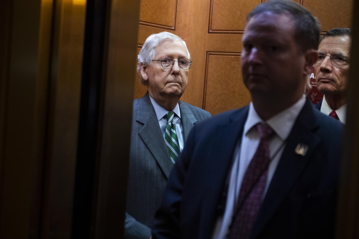 Senate Minority Leader Mitch McConnell, R-Ky., left, and Sen. John Barrasso, R-Wyo., right, head to a news conference in the Capitol on June 17.