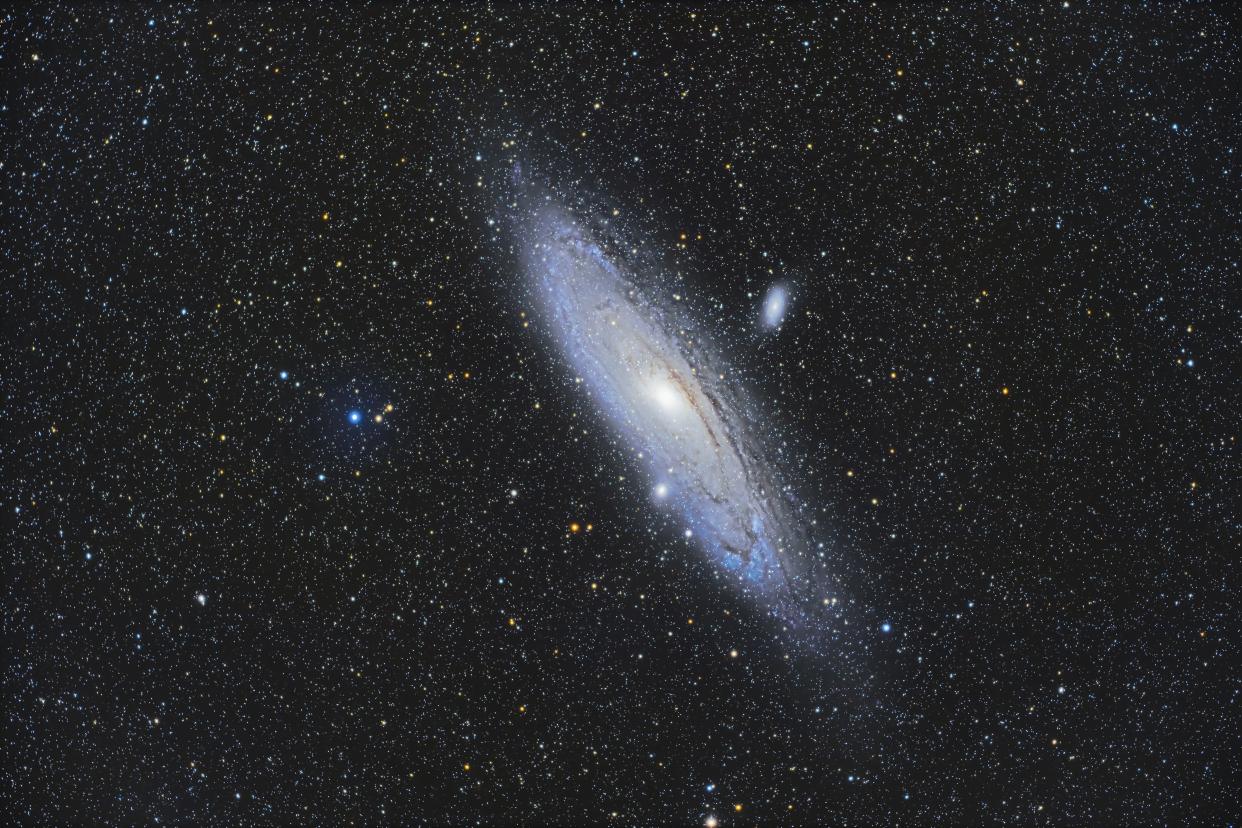 The well-known Andromeda Galaxy, Messier 31, with its companion galaxies. M32, below it and seemingly embedded in M31's outer arms, and M110 above M31. Many yellow giant stars litter the field, as foreground stars in our Milky Way Galaxy. North is up in this framing. This is a stack of 6 x 8-minute exposures at ISO 800 with the Canon Ra and on the StarField Optics Géar80 apo refractor with its matching reducer/flattener for f/4.8. Taken from home through breaks in passing clouds as part of testing of this new scope. No darks or LENR used, just dithering between each frame using the MGEN autoguider. High pass sharpening and a Starizona Galaxy Enhance effect was added to bring out the dark dust lanes. (Photo by: Alan Dyer/VW Pics/Universal Images Group via Getty Images)