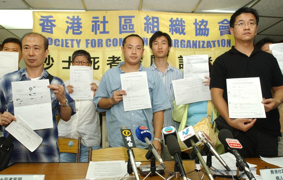 Relatives of SARS victims hold death certificates of their loved ones at the start of a news conference in Hong Kong, Friday Oct. 3, 2003.