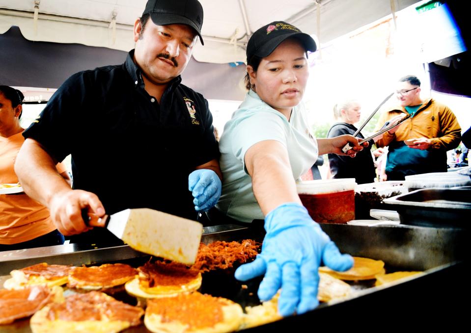 Isabella Pinto and Francisco Campos cook together for Taqueria El Eden during the Taco Wars event Saturday afternoon, April 29, 2023, at the Shreveport Municipal Auditorium. 