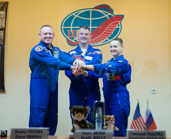NASA astronaut Barry Wilmore (left) and Russian cosmonauts Alexander Samokutyaev and Elena Serova pose for a crew photo after press conference held at the Cosmonaut Hotel in Baikonur, Kazakhstan on Sept. 24, 2014. They will launch from Baikonur