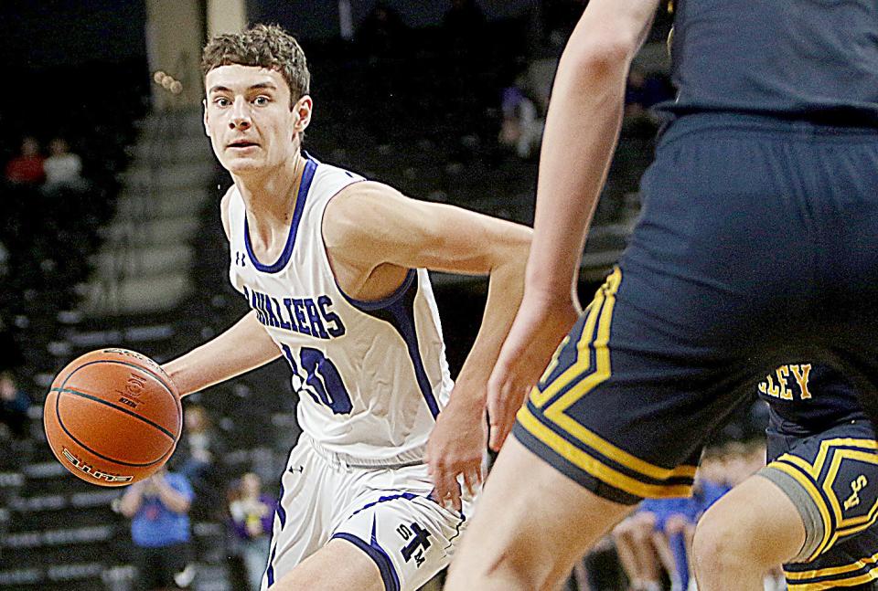 St. Thomas More's Caleb Hollenbeck handles the ball during a semifinal game against Sioux Valley in the 2022 state Class A high school boys basketball tournament at Rapid City.