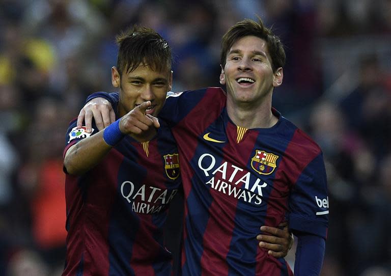 Barcelona's forward Neymar (L) and Lionel Messi (R) celebrate after scoring a goal during the Spanish league football match Barcelona vs Getafe at the Camp Nou stadium in Barcelona on April 28, 2015