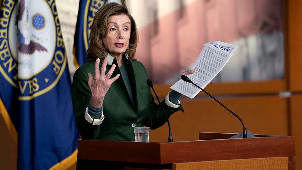 Speaker Nancy Pelosi (D-Calif.) holds the America COMPETES Act as she addresses reporters during her weekly press conference on Thursday, February 3, 2022.