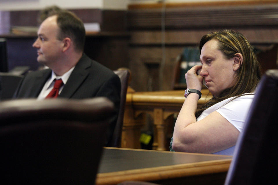 Kelli Jo Griffin, Montrose, Iowa, wipes away tears as she listens with her attorney Curtis Dial, left, to a not guilty verdict Thursday March 20, 2014 in Keokuk, Iowa. The former drug offender, who believed her voting rights had been restored when she cast a ballot last year, was acquitted of perjury - a public rebuke of Iowa's two-year investigation into voter fraud. It was the first trial stemming from the state's voter fraud investigation championed by Secretary of State Matt Schultz, a Republican. (AP Photo/The Hawk Eye, John Gaines)