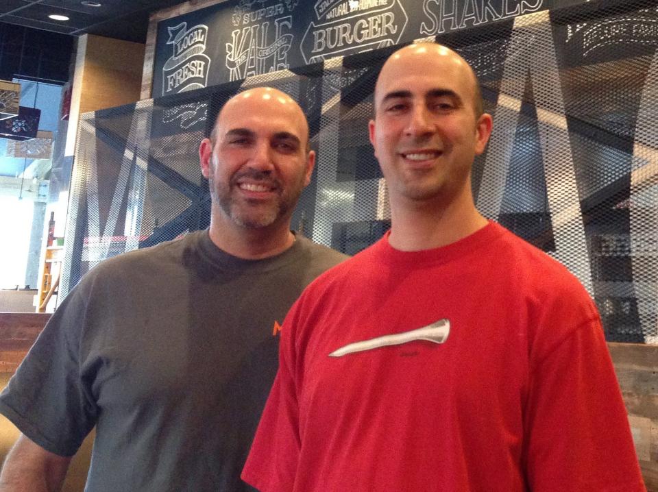 From left, Matthew and David Medure are shown at their M Shack craft burger restaurant before its opening at St. Johns Town Center in 2013.