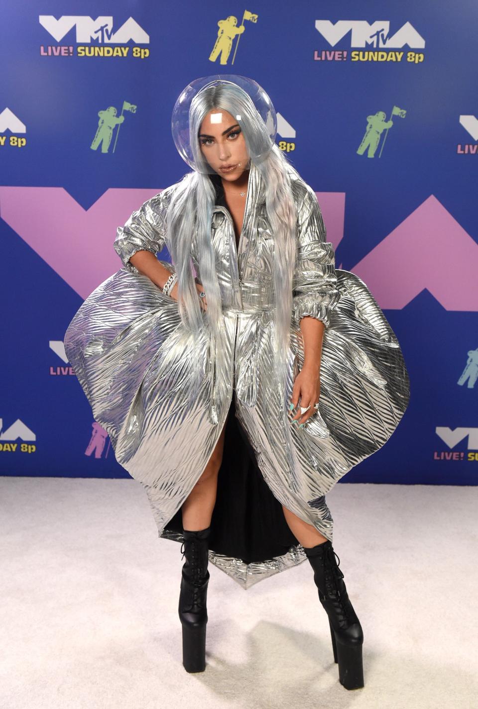 Lady Gaga kept her red carpet outfit COVID-safe with what looked like a space helmet with a futuristic silver dress. Photo: Getty