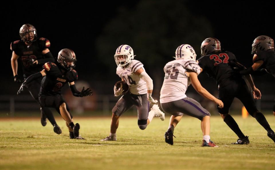 Shasta's Owen Boesiger (center) rushes for a first down in the 2nd quarter against West Valley at the Pasture on Friday, Sept. 8, 2023.