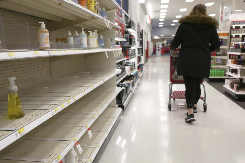 FILE - In this March 3, 2020 file photo, shelves that held hand sanitizer and hand soap are mostly empty at a Target in Jersey City, N.J.    People who may have been exposed to the new coronavirus or who get sick with COVID-19 may be advised to stay home for as long as 14 days to keep from spreading it to others, according to the Centers for Disease Control. That’s led many people to wonder if they could manage for two weeks at home without a run to the grocery store.   (AP Photo/Seth Wenig)