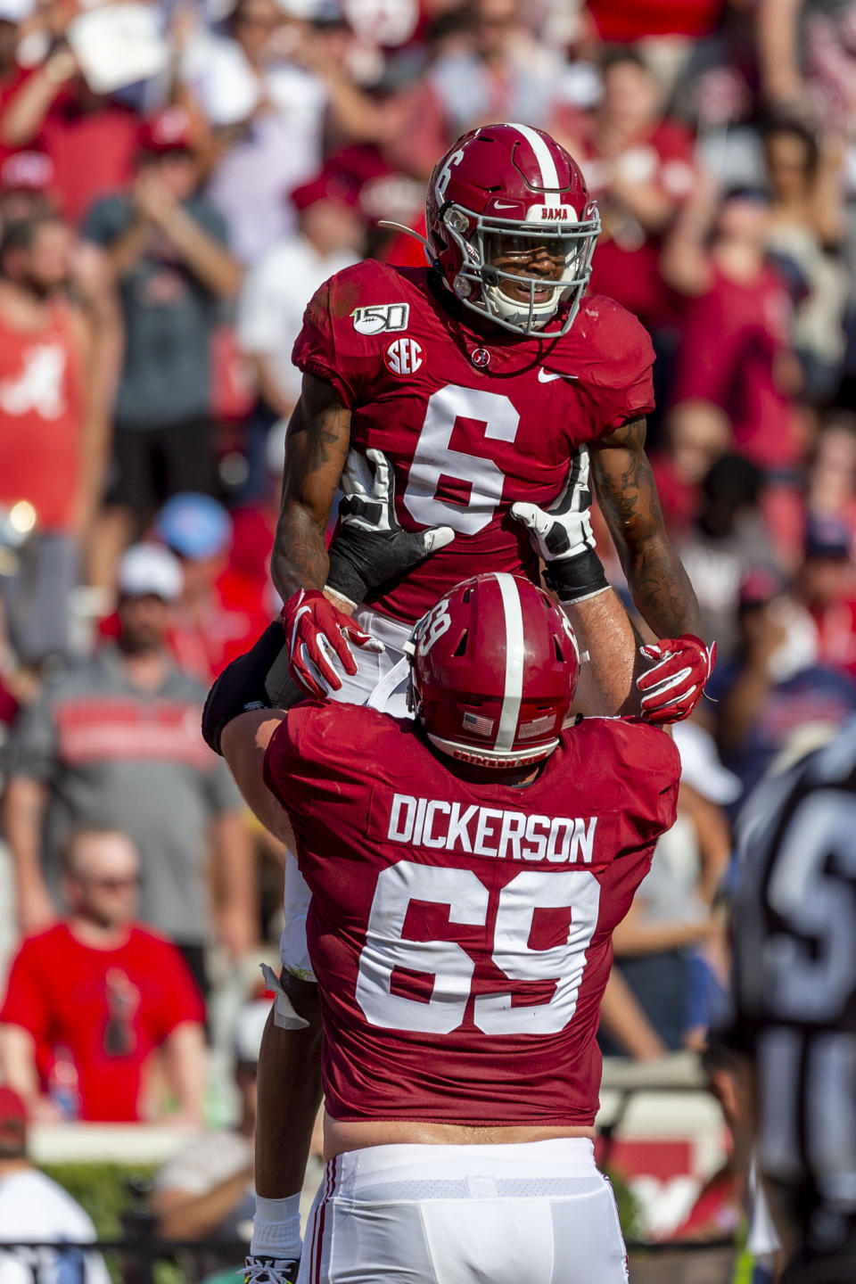 Alabama offensive lineman Landon Dickerson (69) lifts Alabama wide receiver DeVonta Smith (6) to celebrate Smith's touchdown against Mississippi during the first half of an NCAA college football game, Saturday, Sept. 28, 2019, in Tuscaloosa, Ala. (AP Photo/Vasha Hunt)