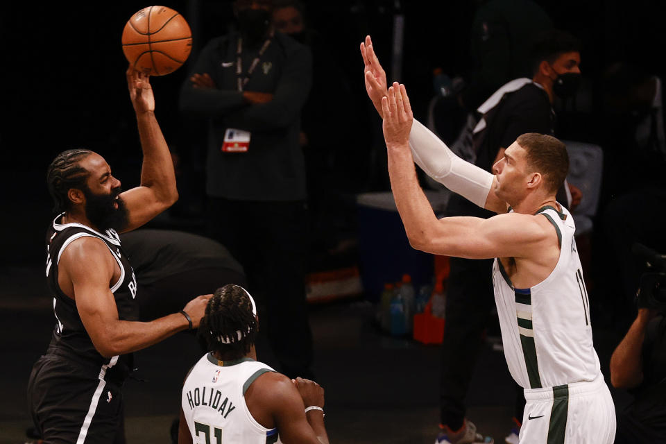 James Harden #13 of the Brooklyn Nets tries to passover Brook Lopez #11 of the Milwaukee Bucks during the first quarter against the Milwaukee Bucks during Game One of the Eastern Conference second round series at Barclays Center on June 05, 2021 in New York City. NOTE TO USER: User expressly acknowledges and agrees that, by downloading and or using this photograph, User is consenting to the terms and conditions of the Getty Images License Agreement. (Photo by Tim Nwachukwu/Getty Images)