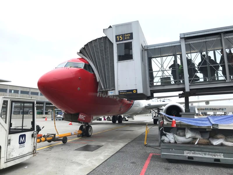Passengers board a Norwegian Air plane at Oslo Gardermoen airport