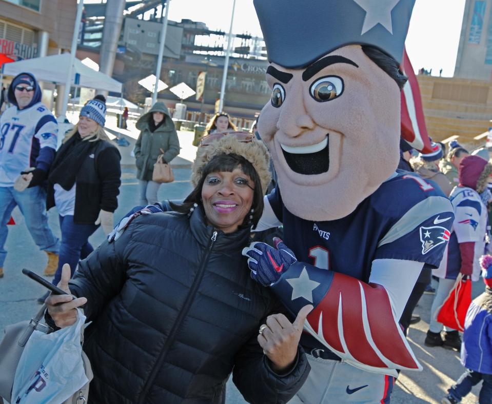 A fan gets a photo with Pat Patriot, who will be available when New England opens training camp this week.