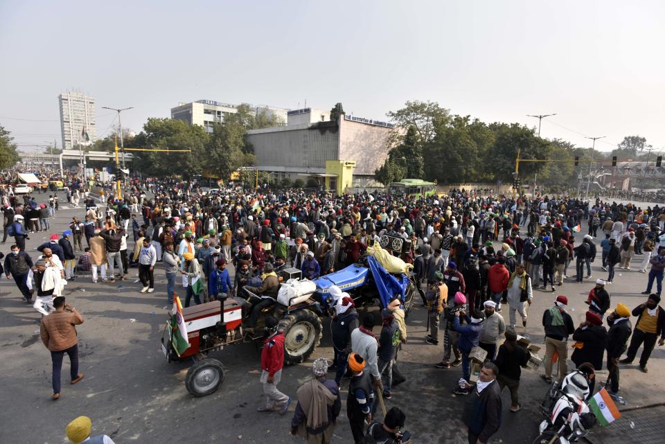 NEW DELHI, INDIA - JANUARY 26: Demonstrators in large numbers at ITO during the farmers' tractor rally on Republic Day, on January 26, 2021 in New Delhi, India. Major scenes of chaos and mayhem at Delhi borders as groups of farmers allegedly broke barricades and police check posts and entered the national capital before permitted timings. Police used tear gas at Delhi's Mukarba Chowk to bring the groups under control. Clashes were also reported at ITO, Akshardham. Several rounds of talks between the government and protesting farmers have failed to resolve the impasse over the three farm laws. The kisan bodies, which have been protesting in the national capital for almost two months, demanding the repeal of three contentious farm laws have remained firm on their decision to hold a tractor rally on the occasion of Republic Day.(Photo by Sanjeev Verma/Hindustan Times via Getty Images)