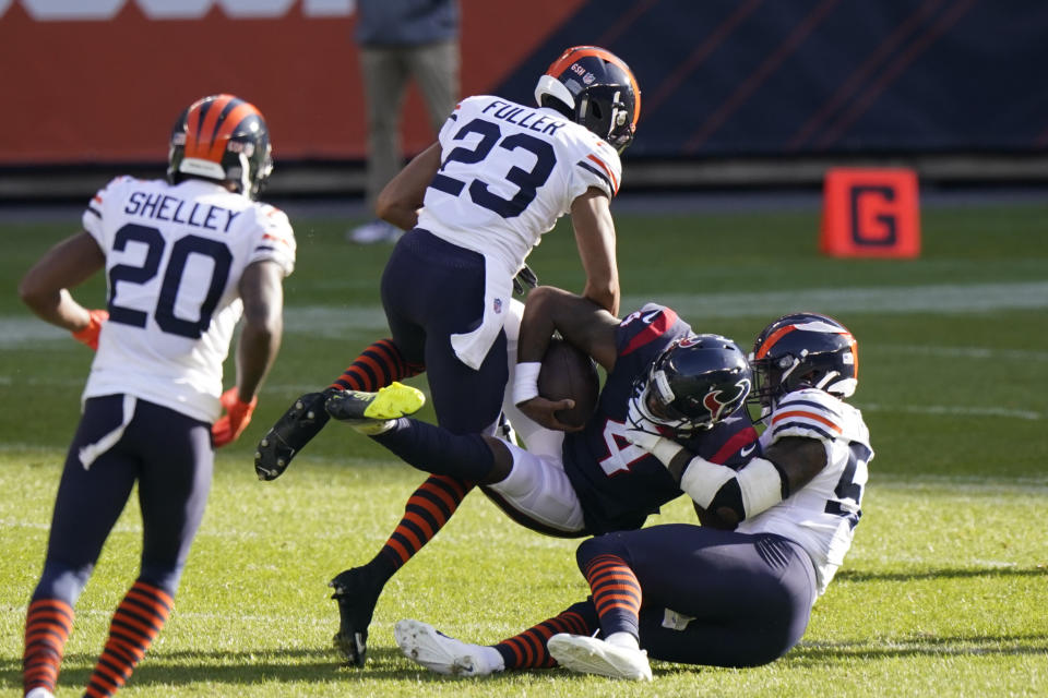 Houston Texans quarterback Deshaun Watson (4) is tackled by Chicago Bears' Kyle Fuller (23) and Danny Trevathan (59) during the first half of an NFL football game, Sunday, Dec. 13, 2020, in Chicago. (AP Photo/Nam Y. Huh)