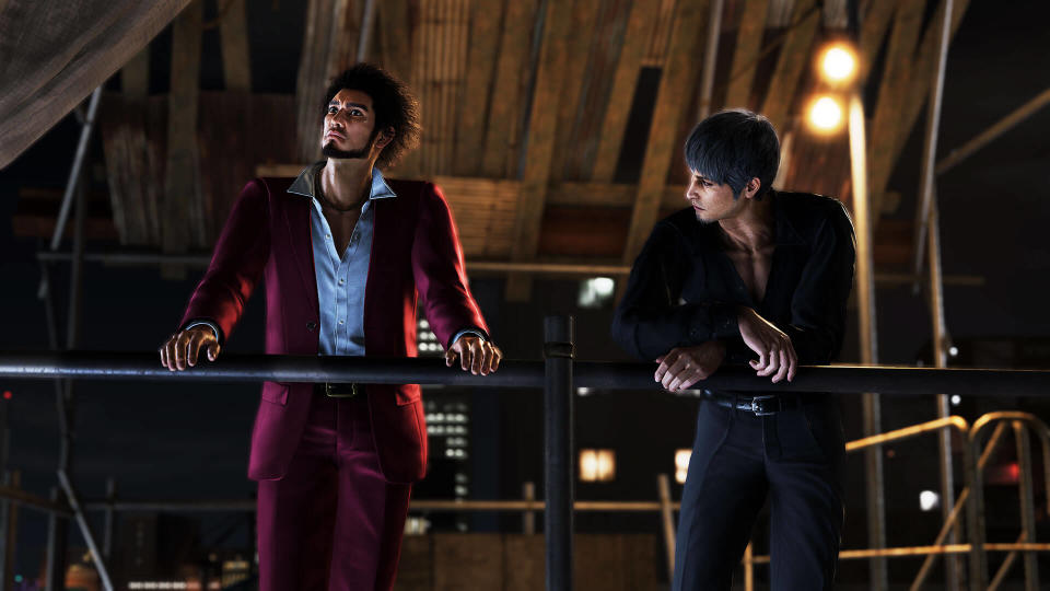 Ichiban and Kiryu stand side by side, leaning over a railing