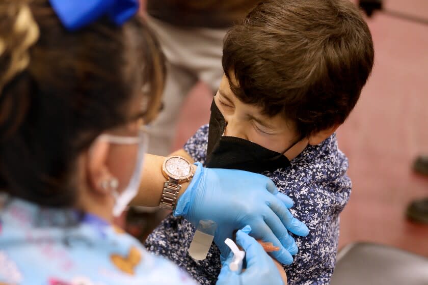 LOS ANGELES, CA - NOVEMBER 03: Luxiano (cq) Gonzalez, 8, of El Monte, receives a child's dose of the Pfizer vaccination from LVN Jacqueline Valdez at Eugene A. Obregon Park on Wednesday, Nov. 3, 2021 in Los Angeles, CA. The County of Los Angeles, including Supervisor Hilda L. Solis, Dr. Barbara Ferrer, Director of Public Health, and Norma Edith Garcia-Gonzalez, Director of Parks and Recreation, will host a media event kicking off COVID-19 vaccinations for children ages 5-11 in Los Angeles County. The COVID-19 vaccine manufactured by Pfizer and BioNTech is proposed to be given in two 10-microgram (mcg) doses administered 21 days apart. (Gary Coronado / Los Angeles Times)