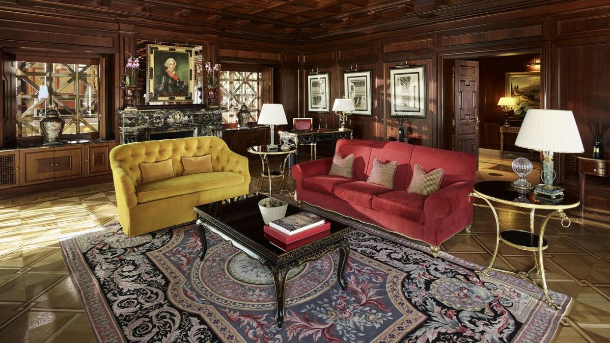 principe di savoia living room with a rug and a couch