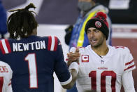 New England Patriots quarterback Cam Newton, left, and San Francisco 49ers quarterback Jimmy Garoppolo speak at midfield after an NFL football game, Sunday, Oct. 25, 2020, in Foxborough, Mass. (AP Photo/Charles Krupa)