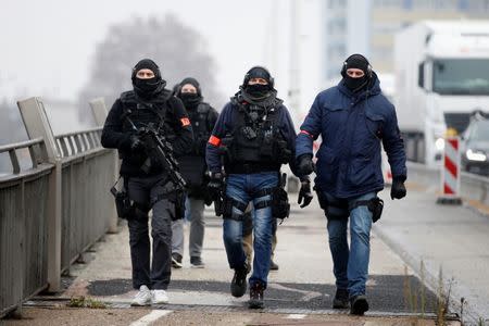 Members of French special police forces of Research and Intervention Brigade (BRI) patrol at the French-German border the day after a shooting in Strasbourg, France, December 12, 2018. REUTERS/Vincent Kessler